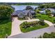 Two-story home boasting lush landscaping, an inviting circular driveway, and waterfront view at 4301 Down Point Ln, Windermere, FL 34786