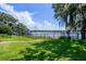 Scenic backyard view showcasing a fenced yard, lake access, and a private dock at 4301 Down Point Ln, Windermere, FL 34786