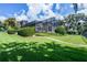 Expansive backyard featuring lush green lawn, mature trees, and a charming walkway at 4301 Down Point Ln, Windermere, FL 34786