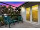 This balcony features tile floors, outdoor seating and a metal railing, perfect for enjoying the tropical landscape at 4301 Down Point Ln, Windermere, FL 34786