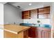 Home bar with cherry cabinets, a wine rack and blue countertop at 4301 Down Point Ln, Windermere, FL 34786