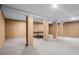 Spacious basement features a ping pong table and structural supports throughout at 4301 Down Point Ln, Windermere, FL 34786