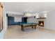 Spacious basement featuring a pool table, tile floors, and a cozy fireplace at 4301 Down Point Ln, Windermere, FL 34786