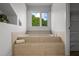 Bathroom soaking tub with tile surround and a window offering exterior views at 4301 Down Point Ln, Windermere, FL 34786