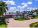 Two-story home boasting lush landscaping, a circular driveway, garage, and inviting entryway at 4301 Down Point Ln, Windermere, FL 34786
