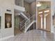 Modern foyer with a staircase and large front door at 4301 Down Point Ln, Windermere, FL 34786