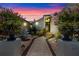 Inviting front entrance at dusk with illuminated landscaping, potted flowers, and pathway at 4301 Down Point Ln, Windermere, FL 34786
