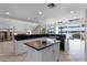 Open kitchen with granite countertops, island, and large windows with water views at 4301 Down Point Ln, Windermere, FL 34786