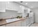 Classic white kitchen featuring ample cabinetry, neutral countertops, and essential appliances at 4301 Down Point Ln, Windermere, FL 34786
