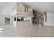 Bright and airy open-concept living space with a high ceiling, adjacent to a modern kitchen and staircase at 4301 Down Point Ln, Windermere, FL 34786
