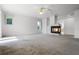 Spacious living room features a cozy fireplace, neutral carpet, and ample natural light from multiple windows at 4301 Down Point Ln, Windermere, FL 34786