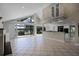 Open-concept living room with high ceilings and a full lake view featuring a modern kitchen and balcony at 4301 Down Point Ln, Windermere, FL 34786