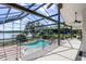 Spacious patio with a screened-in pool area and stunning lake views is perfect for entertaining at 4301 Down Point Ln, Windermere, FL 34786