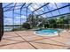 Large screen enclosed pool area with pool, patio, and scenic view at 4301 Down Point Ln, Windermere, FL 34786