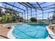 Screened pool area with a pool, patio, and views of surrounding greenery and lake at 4301 Down Point Ln, Windermere, FL 34786