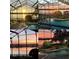 A collage of backyard views featuring a serene pool area overlooking a stunning sunset over the lake at 4301 Down Point Ln, Windermere, FL 34786