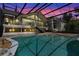 Rear view of a home showcasing a spacious, screened-in pool area with a connecting staircase at 4301 Down Point Ln, Windermere, FL 34786