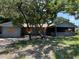 Exterior view of a single-story home with boarded windows and a screened-in porch at 4302 Seybold Ave, Orlando, FL 32808