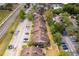 Aerial view of townhome community with parking, landscaping, and road access at 5060 Downing St # 6, Orlando, FL 32839
