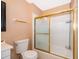 Traditional bathroom featuring white tile, shower with glass door, and gold hardware at 5060 Downing St # 6, Orlando, FL 32839