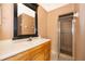Bathroom with wooden vanity, large mirror, and walk-in shower at 5060 Downing St # 6, Orlando, FL 32839