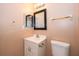 Cozy bathroom featuring tile floors, single sink vanity, and framed mirror at 5060 Downing St # 6, Orlando, FL 32839