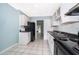 A fully-equipped kitchen with stainless steel sink and black appliances at 5060 Downing St # 6, Orlando, FL 32839
