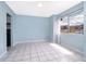 Cozy living room with white ceramic tile and a window at 5060 Downing St # 6, Orlando, FL 32839