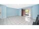 Spacious, bright room featuring sliding door, ceramic tile flooring at 5060 Downing St # 6, Orlando, FL 32839