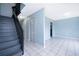 Open-concept floor plan with ceramic tile flooring, stairs and freshly painted blue walls at 5060 Downing St # 6, Orlando, FL 32839