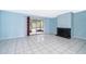 Light-filled living room boasts tile floors, sliding doors to screened porch, and fireplace at 5060 Downing St # 6, Orlando, FL 32839