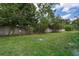 Grassy yard enclosed by a brick wall with surrounding trees offers a private outdoor space at 5060 Downing St # 6, Orlando, FL 32839