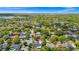 Aerial view of home in a neighborhood with mature trees and a lake view in the distance at 532 Darcey Dr, Winter Park, FL 32792