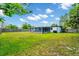 Spacious backyard featuring a lush lawn, screened patio, fence, and mature trees, offering a private outdoor space for recreation at 532 Darcey Dr, Winter Park, FL 32792