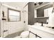 Modern bathroom features white subway tiles, glass-enclosed shower, gray accent wall, and sleek vanity at 532 Darcey Dr, Winter Park, FL 32792