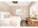 Bright bedroom featuring plantation shutters, wood floors, soft bedding, and stylish furnishings, creating a cozy and elegant space at 532 Darcey Dr, Winter Park, FL 32792