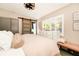Cozy bedroom features a decorative sliding door, neutral decor, wood-look tile floors and ample natural light at 532 Darcey Dr, Winter Park, FL 32792