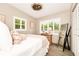 Comfortable bedroom featuring bright windows, a queen-size bed, wood floors, and soft lighting, offering a peaceful retreat at 532 Darcey Dr, Winter Park, FL 32792