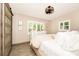 Bright bedroom featuring wood-look tile floors, white shutters, and minimalist decor creates a serene atmosphere at 532 Darcey Dr, Winter Park, FL 32792