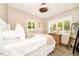 Comfortable bedroom featuring two windows with shutters, a queen-size bed, wood floors, and soft lighting, offering a peaceful retreat at 532 Darcey Dr, Winter Park, FL 32792
