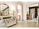 Open entryway with wood-look tile flooring, showcasing a decorative cabinet, mirror, and views into adjacent rooms at 532 Darcey Dr, Winter Park, FL 32792
