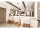 Stylish kitchen with gray cabinets, a breakfast bar, pendant lighting, and stainless steel appliances at 532 Darcey Dr, Winter Park, FL 32792