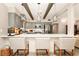 Modern kitchen boasts gray cabinets, a breakfast bar with seating, and decorative pendant lighting at 532 Darcey Dr, Winter Park, FL 32792
