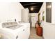 Functional laundry room featuring a washer and dryer, cabinetry, and a window, providing convenience and ample space for laundry tasks at 532 Darcey Dr, Winter Park, FL 32792