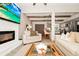 Open-concept living room flows into the kitchen, featuring a fireplace, wood beams, and bar seating at 532 Darcey Dr, Winter Park, FL 32792