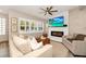 Bright living room boasts a decorative fireplace, plantation shutters, and modern furnishings for relaxation at 532 Darcey Dr, Winter Park, FL 32792