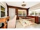 Office area with wood accent wall, desk, large windows, and ample natural light; can also function as flex space at 532 Darcey Dr, Winter Park, FL 32792