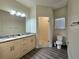 Bright bathroom featuring double vanity, granite countertop, glass-enclosed shower, and modern fixtures at 5354 Diplomat Ct # 105, Kissimmee, FL 34746