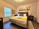 The bedroom features a queen bed with a themed mural, and neutral decor for a comfortable stay at 5354 Diplomat Ct # 105, Kissimmee, FL 34746