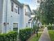 Charming townhome with light blue siding, brown shutters, and well-maintained landscaping at 5354 Diplomat Ct # 105, Kissimmee, FL 34746